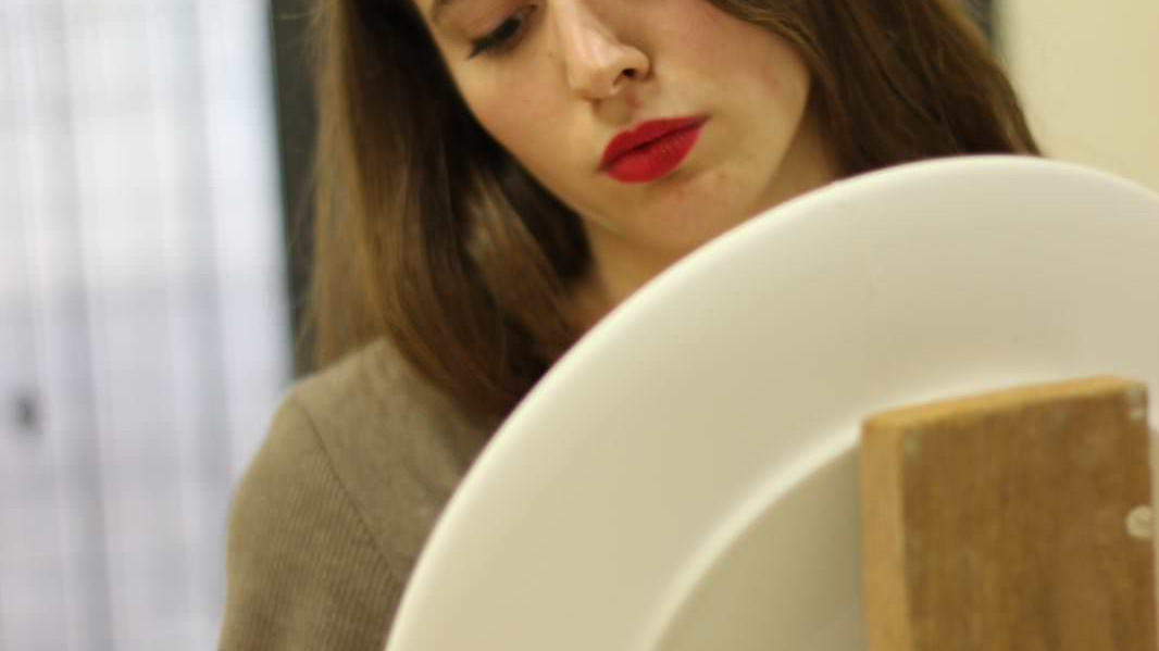 Le ragazze del cantiere decorano piatti in ceramica